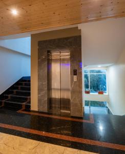 a elevator in a building with a staircase at Wisteria Crystal Manor in Pelling