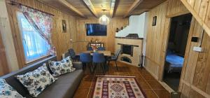 a living room with a couch and a table at Cabana 2 Râuri in Bratca +33 photos