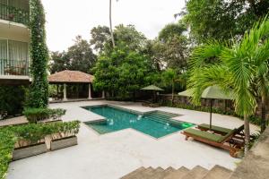 a swimming pool in the middle of a yard at Tropical trails by wija house-unawatuna in Unawatuna