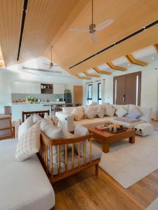 a living room with a couch and a table at Solune Khaoyai Pool Villa in Ban Rai Khlong Sai