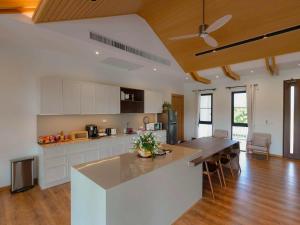 a large kitchen with a large island in a room at Solune Khaoyai Pool Villa in Ban Rai Khlong Sai