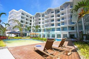 a resort with two chairs and a swimming pool at Luxu Hotel and Resort in Panglao Island