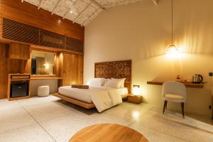 a bedroom with a large bed and a table at Tropical trails by wija house-unawatuna in Unawatuna +68 photos