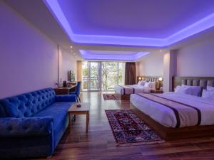 a hotel room with a large bed and a couch at Wisteria Crystal Manor in Pelling +105 photos