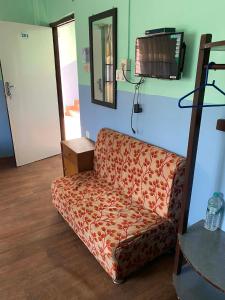a living room with a couch and a tv at Hotel Marcopolo in Pokhara