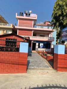 a red brick building with a gate in front of it at Hotel Marcopolo in Pokhara