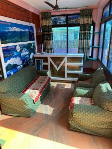a living room with two couches and a table at Hotel Marcopolo in Pokhara