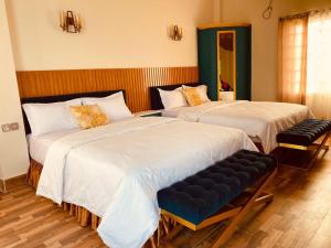 two beds sitting next to each other in a room at Eastern Heritage Resort in Mymensingh +42 photos