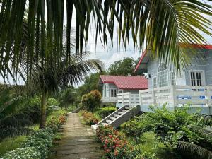 a house with a staircase leading up to a house at Eastern Heritage Resort in Mymensingh