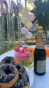 a table with donuts and a bottle of champagne and a cake at Eastern Heritage Resort in Mymensingh