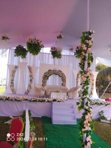 a white tent with a table with flowers on it at Eastern Heritage Resort in Mymensingh
