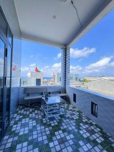 a balcony with a table and a view of the beach at Homestay Hoàng Phúc in Cu Lao Thu
