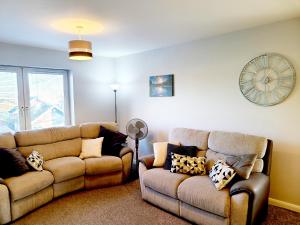 a living room with a couch and a chair at Parkside Apartment Normanton in Wakefield