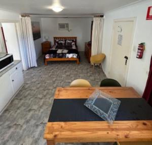 a bedroom with a table and a bed in a room at KI Caravan Park, Kingscote in Kingscote