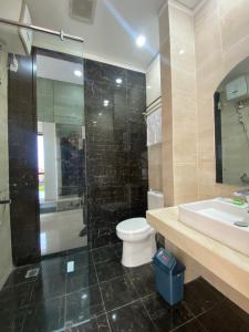 a bathroom with a toilet and a sink and a shower at Pavo Guest House in Minangkabau International Airport +29 photos