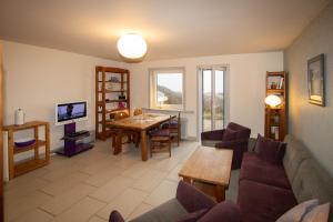 a living room with a couch and a table at Stranddüne in Hörnum