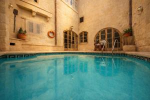a large swimming pool in a building at Ta' Frenc Farmhouse in Għarb