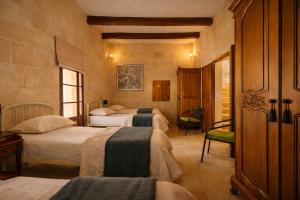 a bedroom with three beds in a room at Ta' Frenc Farmhouse in Għarb +17 photos