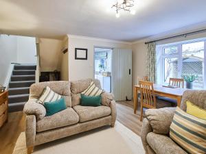 a living room with two chairs and a couch and a table at Cobblers Cottage in Barnard Castle