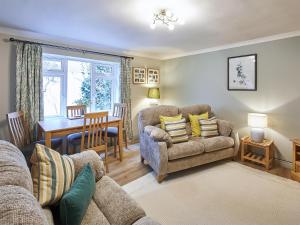 a living room with a couch and a table at Cobblers Cottage in Barnard Castle