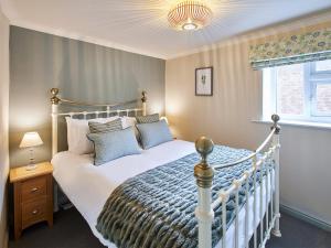 a bedroom with a white bed and a window at Cobblers Cottage in Barnard Castle +10 photos