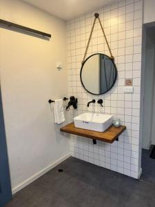 a bathroom with a sink and a mirror on the wall at Mira Apartments 2BR Apartment in Nadi Free Parking & WiFi in Nadi +26 photos