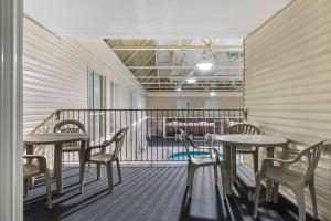 a balcony with two tables and chairs and a cafeteria at Clarion Hotel & Suites in Brandon