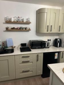 a kitchen with a sink and a microwave at Swansea Waterfront in Swansea