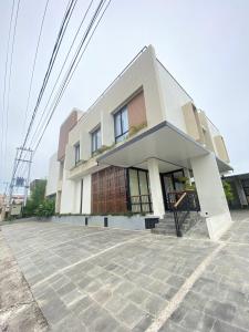 a large white building on a street at Pavo Guest House in Minangkabau International Airport