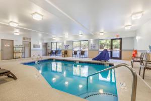 a large swimming pool in a hotel room with a pool at Comfort Suites Columbia Northeast - Fort Jackson in Dentsville