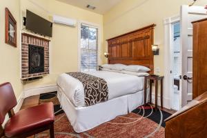 a bedroom with a bed and a fireplace at Hotel Napa Valley, an Ascend Collection Hotel in Napa