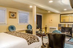 a bedroom with a bed and a fireplace at Hotel Napa Valley, an Ascend Collection Hotel in Napa