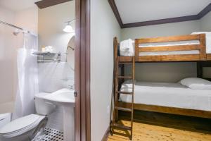 a bathroom with a bunk bed and a toilet and a sink at Water Street Hotel & Marina, an Ascend Collection Hotel in Apalachicola +45 photos