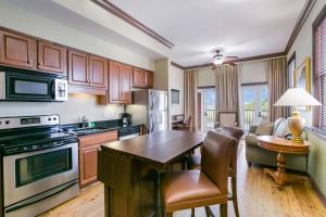 a kitchen with wooden cabinets and a table and chairs at Water Street Hotel & Marina, an Ascend Collection Hotel in Apalachicola