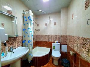 a bathroom with a sink and a toilet and a shower at DREAM PLAZA HOTEL for your convenience in Bukhara