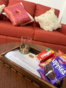 a coffee table with a glass top and snacks on it at The Hampiness in Hospet