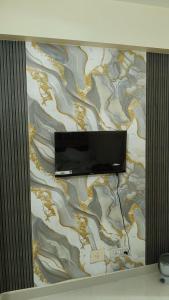 a flat screen tv hanging on a wall at Atithi Stay in Patna