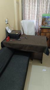 a table with a laptop on top of a bed at Atithi Stay in Patna