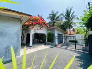 a house with a gate and flowers on it at Coastal villa in Batticaloa