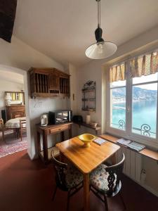 a kitchen with a wooden table and a large window at Menton1974 in Menton