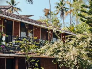 a house with flowers on the side of it at Ambadi's villa -Lake view resort in Pallipuram
