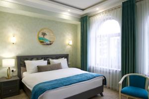 a bedroom with a bed and a window at al Madina Hotel Samarkand in Samarkand +33 photos