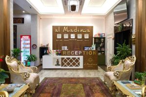 a room with a store with chairs and a counter at al Madina Hotel Samarkand in Samarkand