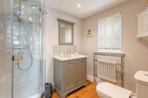 a bathroom with a shower and a sink and a toilet at The Gate Lodge - Pet Free - Near Finchingfield & Saffron Walden in Great Sampford +16 photos