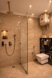 a bathroom with a glass shower with a toilet at Airport Hotel Vella VILLA By Corporate Group Delhi IGI Airport Terminal 3 With Free Airport Pickup in New Delhi +10 photos