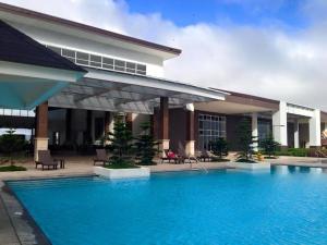 a swimming pool in front of a building at Bella Suites at Wind Residences Tagaytay in Tagaytay