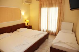 Postel nebo postele na pokoji v ubytování Vasiliki Apartments + 18 fotografií