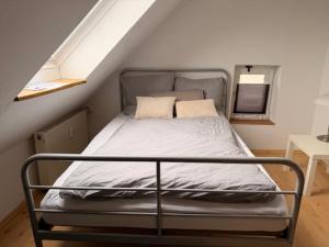 a bed in a small room with a attic at Ferienwohnung Detmold Diestelbruch in Detmold