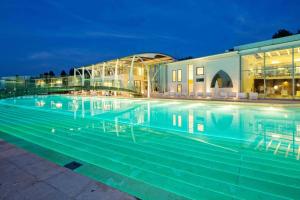 une grande piscine en face d'un bâtiment dans l'établissement Riviera Golf Resort, à San Giovanni in Marignano