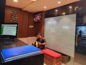 a man standing in front of a desk with a ball at Airport Inn Residency Mumbai in Mumbai